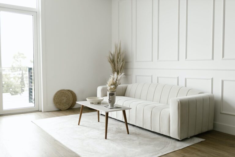 white sofa beside white wall